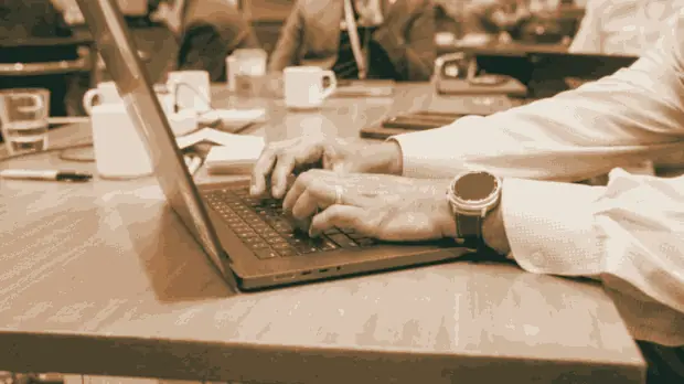 An executive typing on a laptop during the build